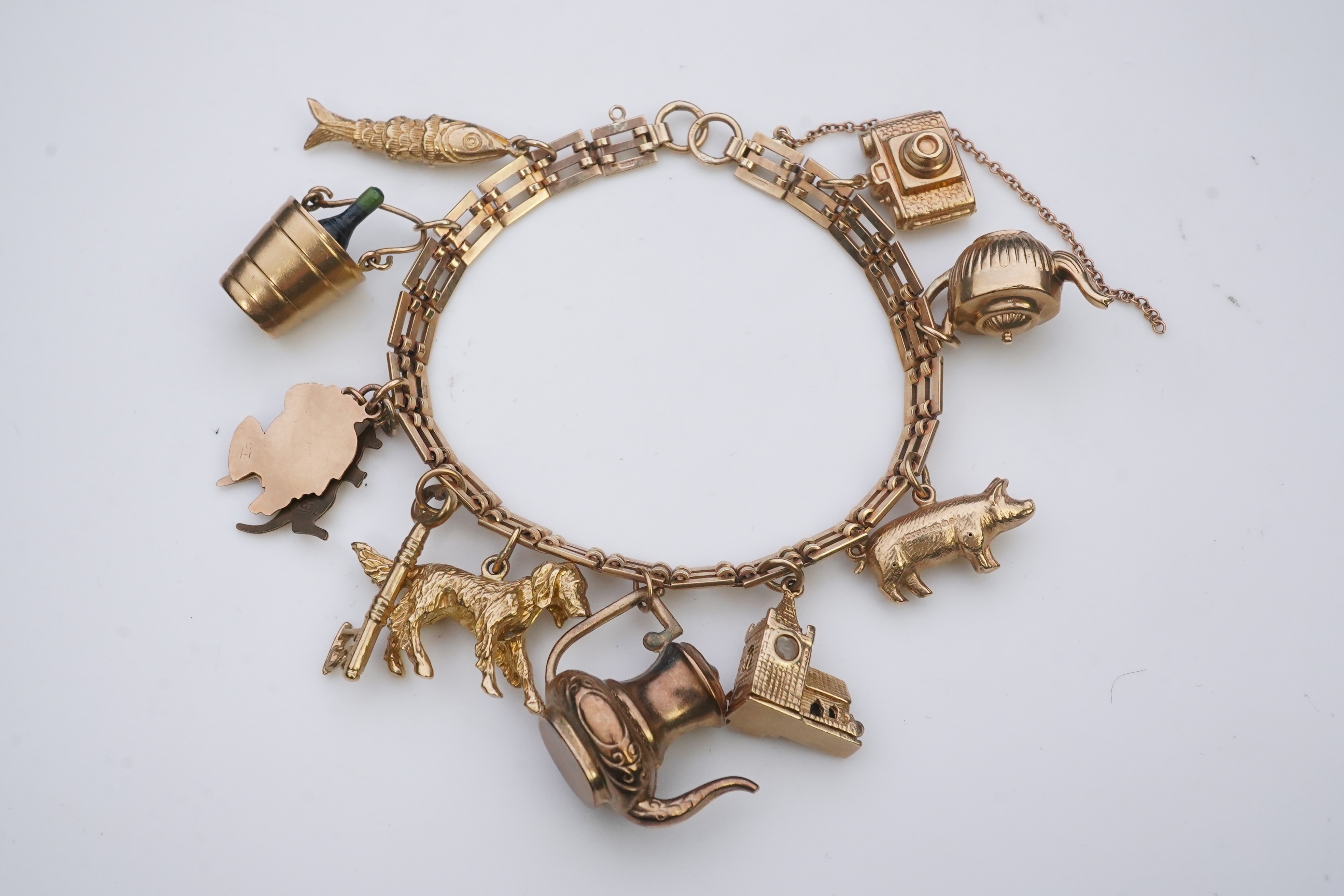 A charm bracelet, mid 20th century